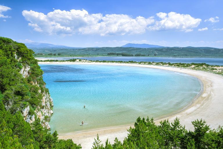 famous-pristine-sunny-beach-voidokilia-in-greece-with-beautiful-golden-beach-sand-summer-sunny-day-skyline-scenery-popular-summer-resort-travel-landmark-and-vacation-destination